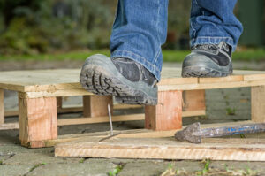 Worker almost stepping on nail