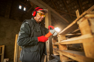 Worker remanufacturing a pallet